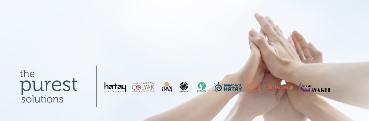 The Purest Solutions özel iş birlikleri: el ele tutuşan eller ve partner logoları — Hatay Sörf Merkezi, Aksaray Çölyak Derneği, YUVA, Koru, Kızçev, Buradayız Hatay, Mutlu Patiler, SMA Vakfı